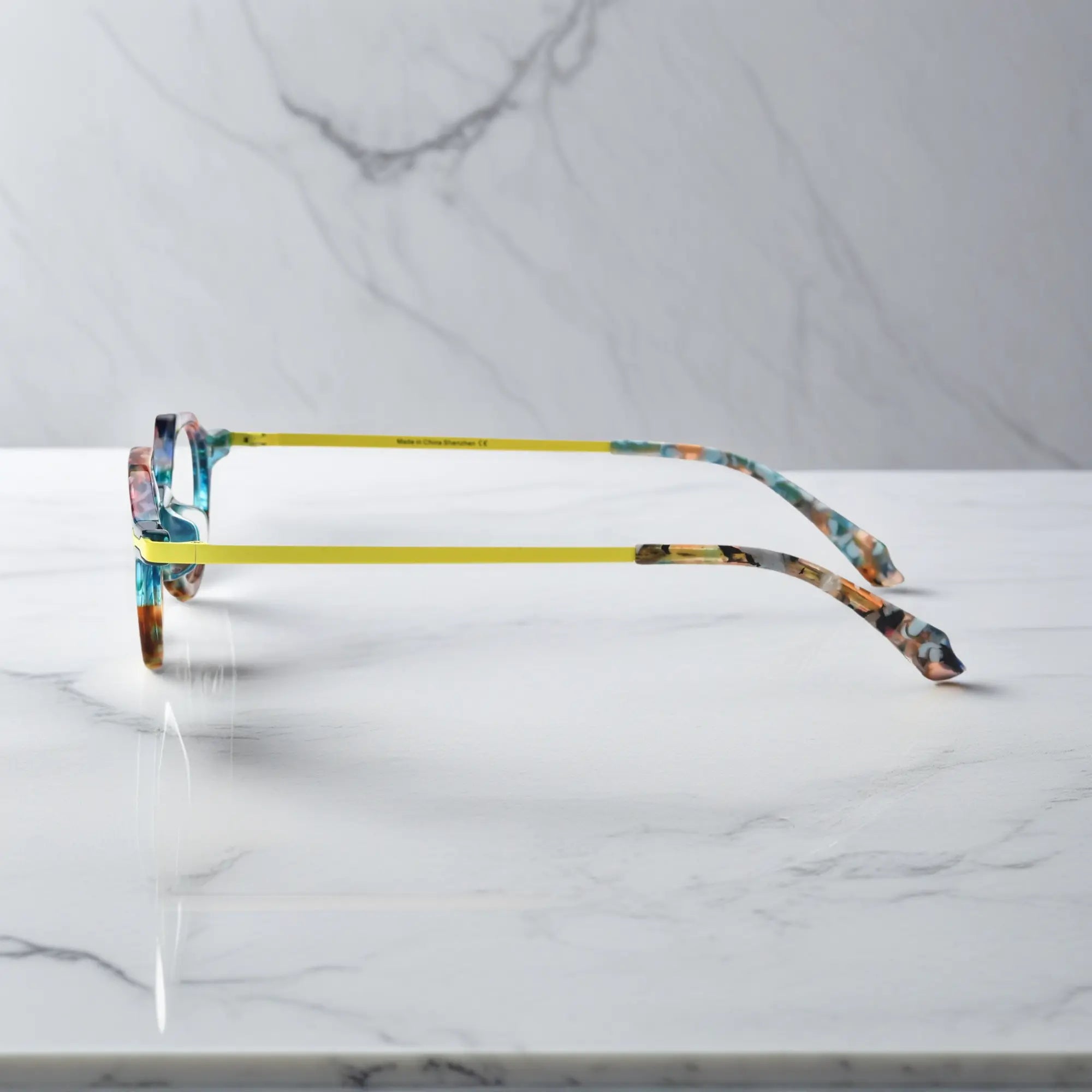 Side profile of VoyueLens™ VL19341 lightweight eyeglasses in amber crystal acetate, featuring slim gold metal temples and integrated nose pads for comfortable daily wear.